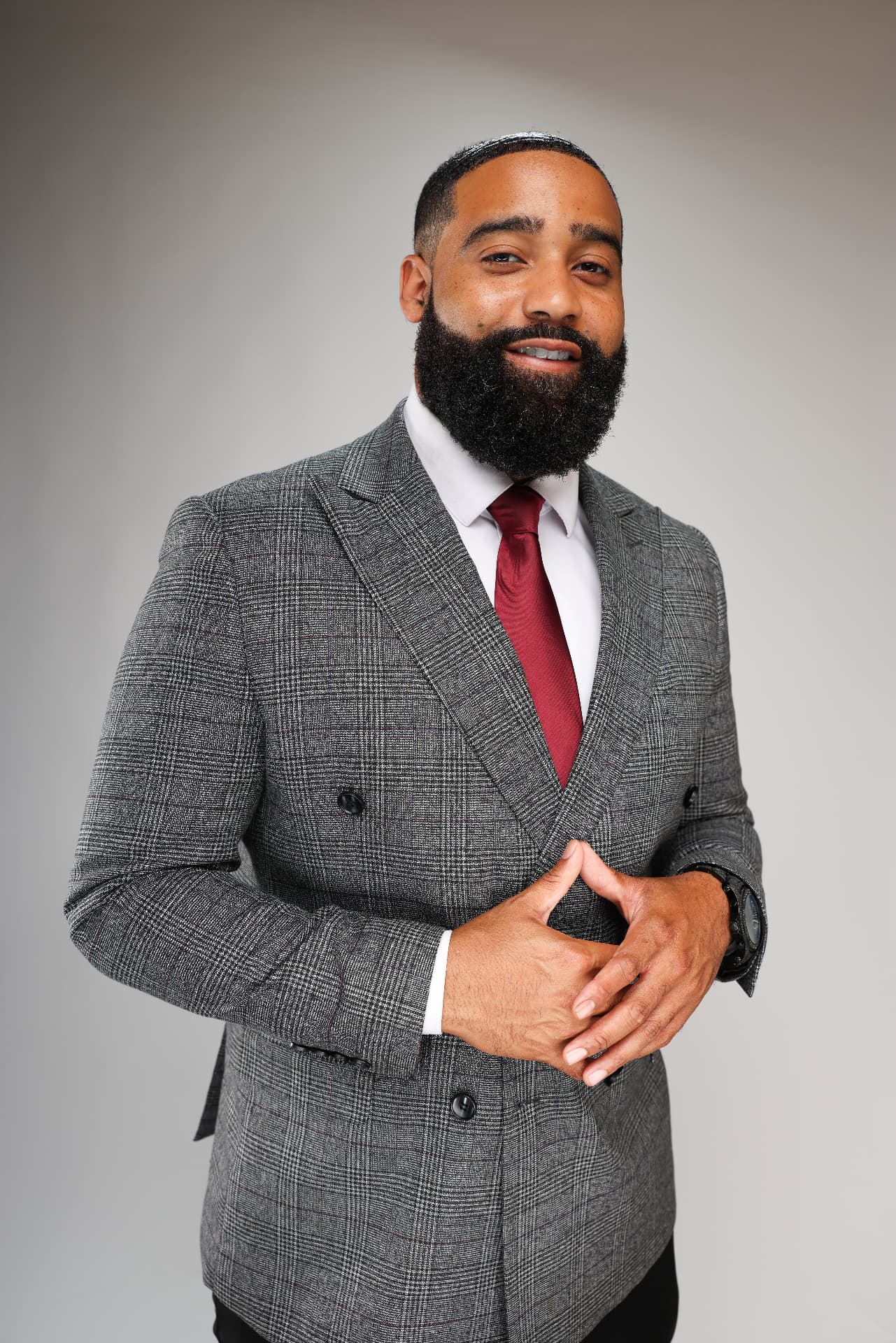 Luke Melton in a gray suit and red tie